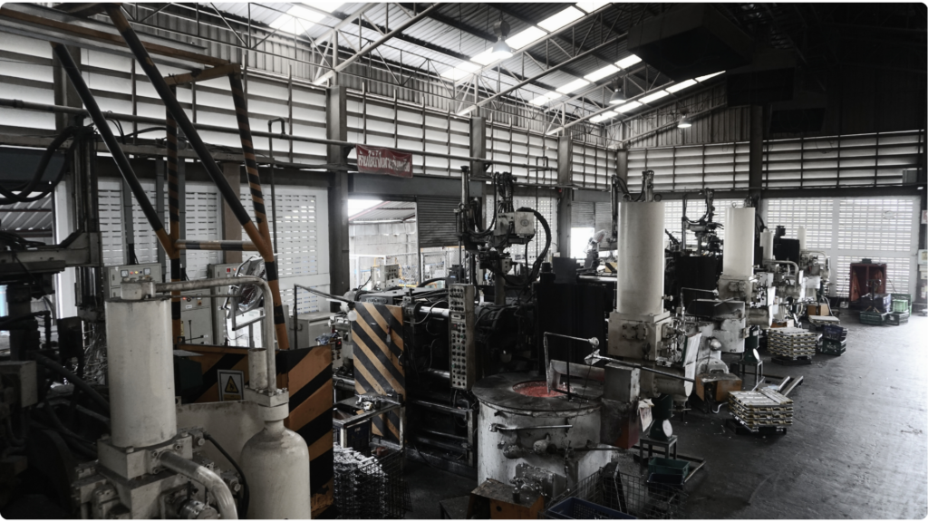 Row of high-pressure die casting machines with a molten aluminium holding furnace