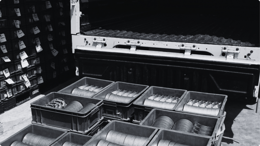 Crates of finished aluminium parts loaded onto a truck for the Delivery step