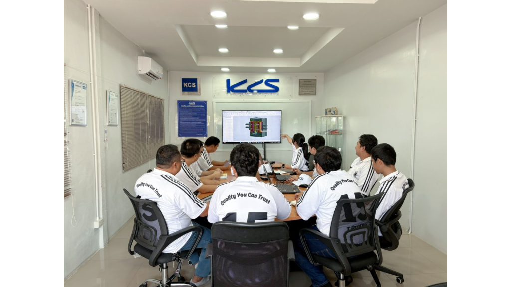 Engineering team at K Casting and Solution reviewing a 3D mould model on a meeting room screen