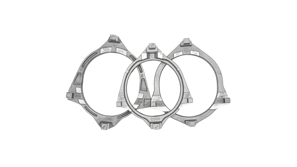 Three die cast aluminium compressor end brackets with machined bearing pads